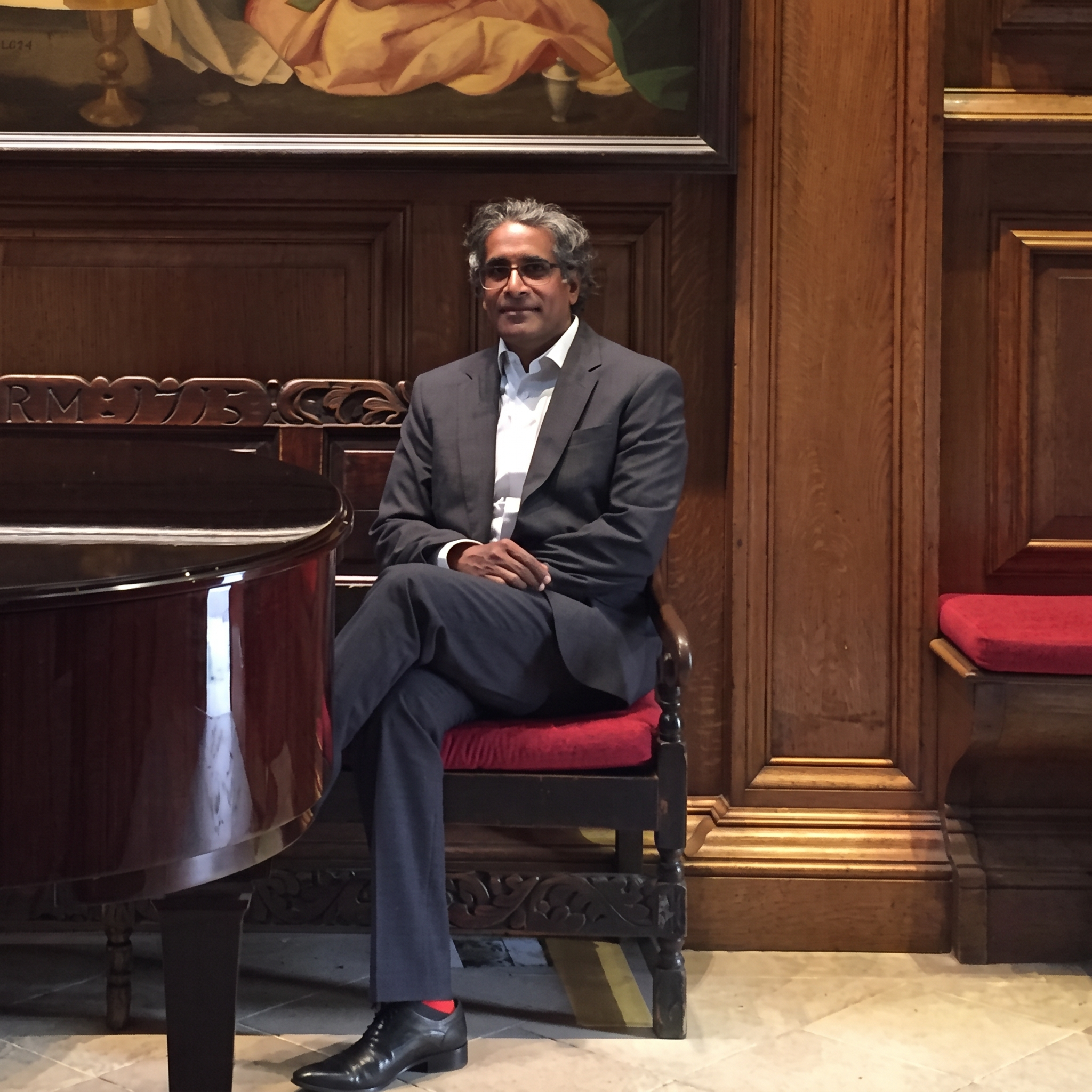 Fazal Ali seated beside a piano
